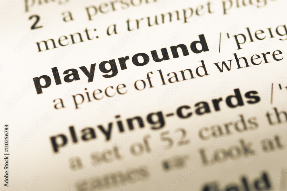 Close up of old English dictionary page with word playground Close up of old English dictionary page with word playground