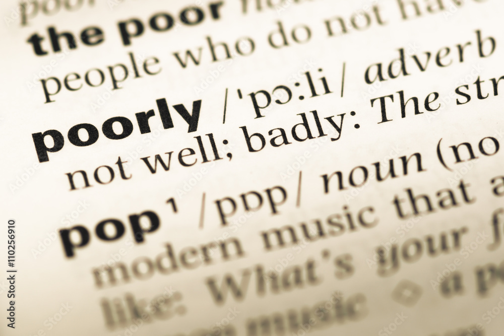 Close up of old English dictionary page with word poorly Close up of old English dictionary page with word poorly