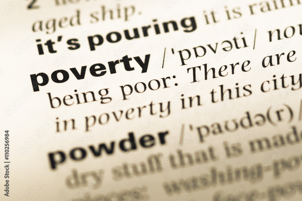 Close up of old English dictionary page with word poverty Close up of old English dictionary page with word poverty