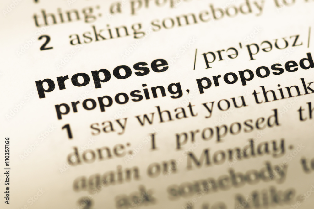 Close up of old English dictionary page with word propose Close up of old English dictionary page with word propose