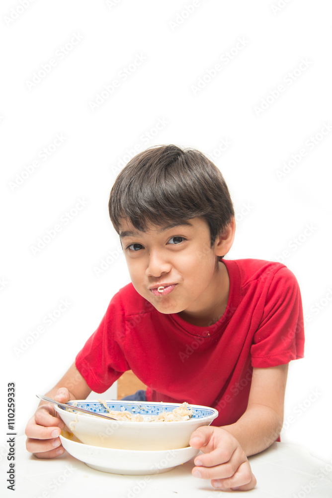 Little boy eating instant noodle on white background Little boy eating instant noodle on white background