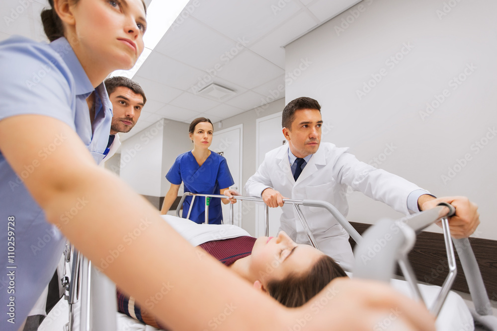 Fototapeta premium medics with woman on hospital gurney at emergency