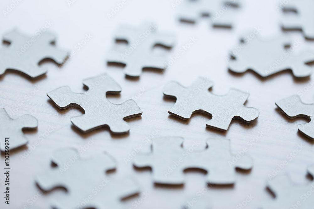 close up of puzzle pieces on table close up of puzzle pieces on table
