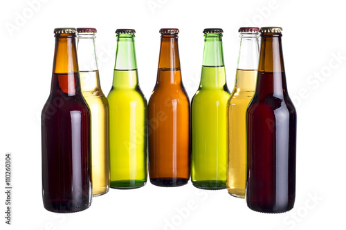 Group of unlabeled variety of beer bottles isolated on a white background.  The colors represent Mexican cervesa. photo