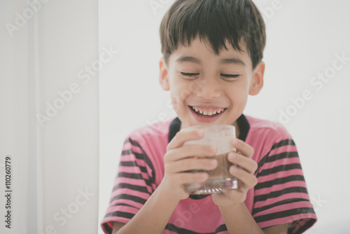 Little boy drinking milk vintage color style