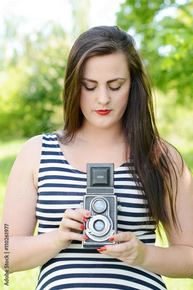 Beautiful young woman with an old camera Beautiful young woman with an old camera