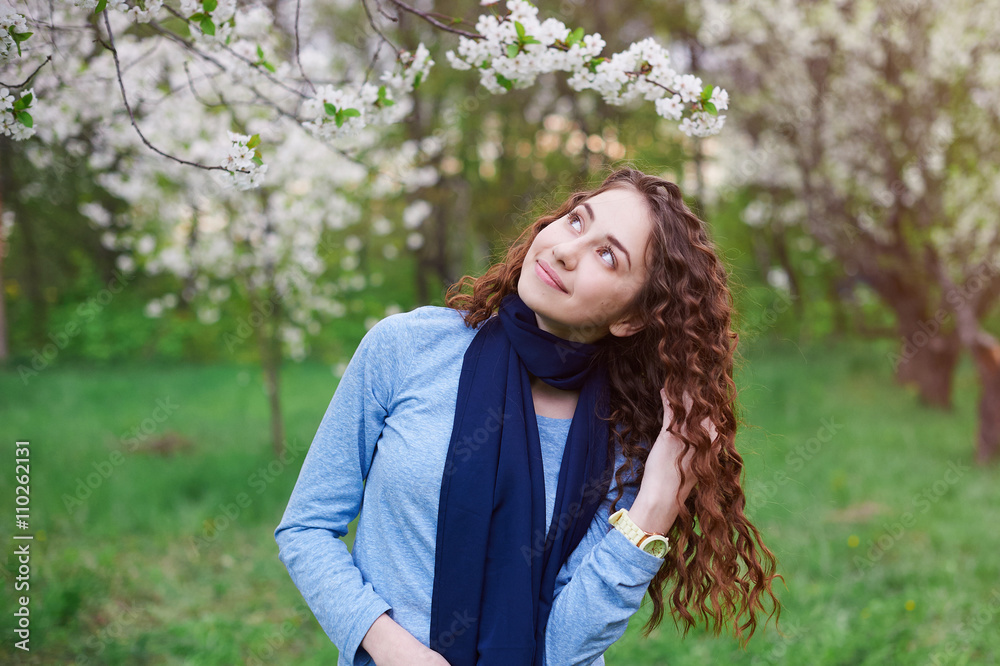 young woman in the blossoming spring garden walks young woman in the blossoming spring garden walks