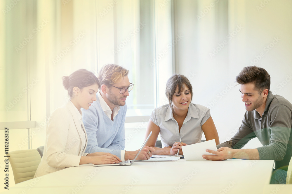Business people meeting around table in modern space