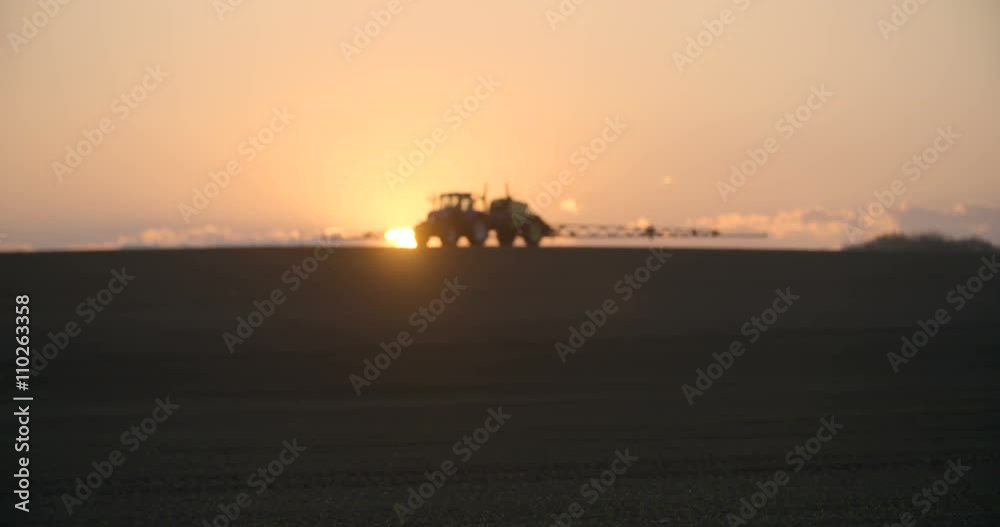 Tractor spray fertilize on field with chemicals in agriculture field. Tractor spray fertilize on field with chemicals in agriculture field.