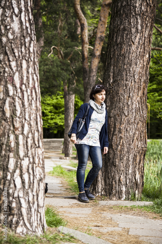 woman in park near a tree thought woman in park near a tree thought
