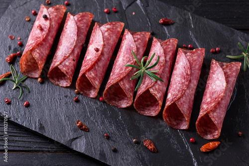 Delicious salami with basil and wine, selective focus