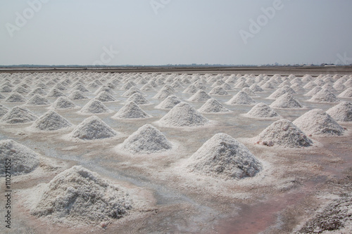 Salt fields with piled up sea salt in Thailand