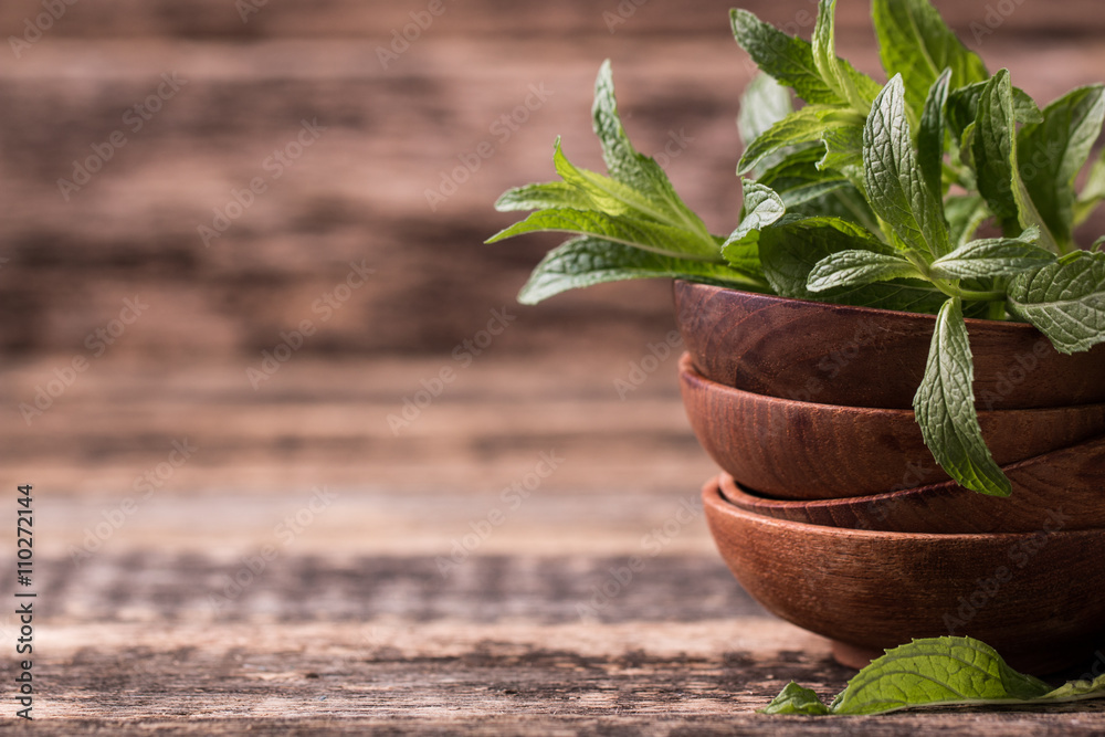Green fresh mint on the wooden table, selective focus Green fresh mint on the wooden table, selective focus