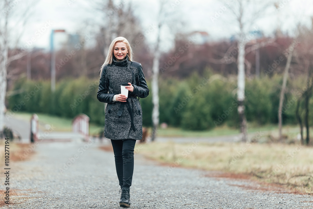 Girl in the park with coffee cup Girl in the park with coffee cup