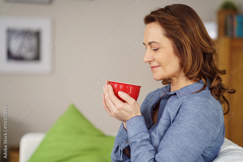 Wunschmotiv: entspannte frau hält eine tasse mit tee in den händen und wärmt sich #110277994