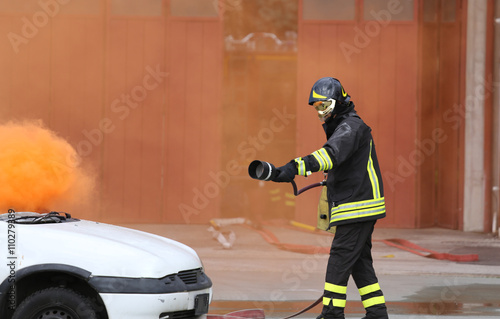 firefighters during exercise to extinguish a fire in a car photo