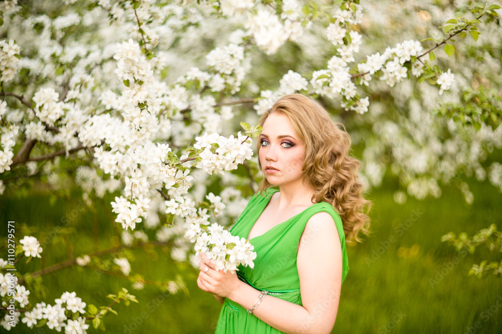 fashion beautiful blonde woman in blossoming garden of Apple trees fashion beautiful blonde woman in blossoming garden of Apple trees
