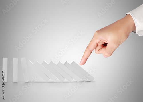 Принти на полотні Hand pushing dominoes concept