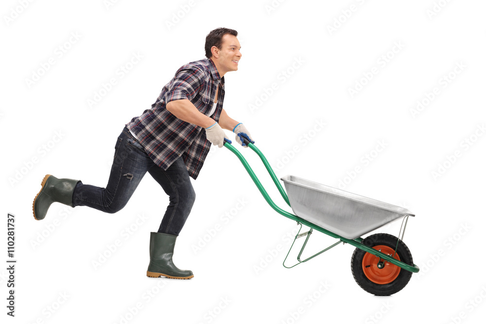 Man pushing wheelbarrow and running Man pushing wheelbarrow and running