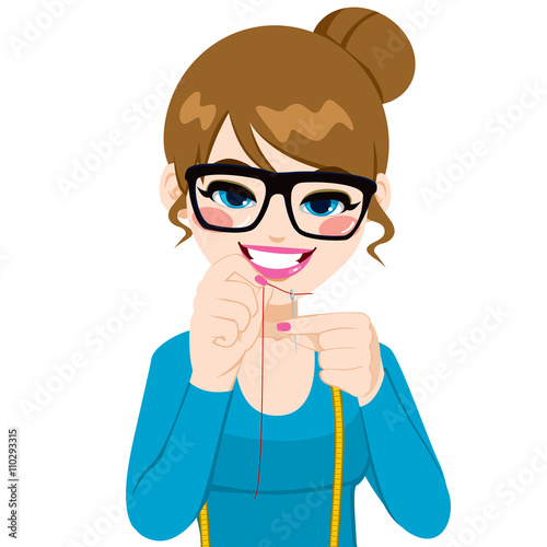 Beautiful young dressmaker woman putting red sewing thread through needle