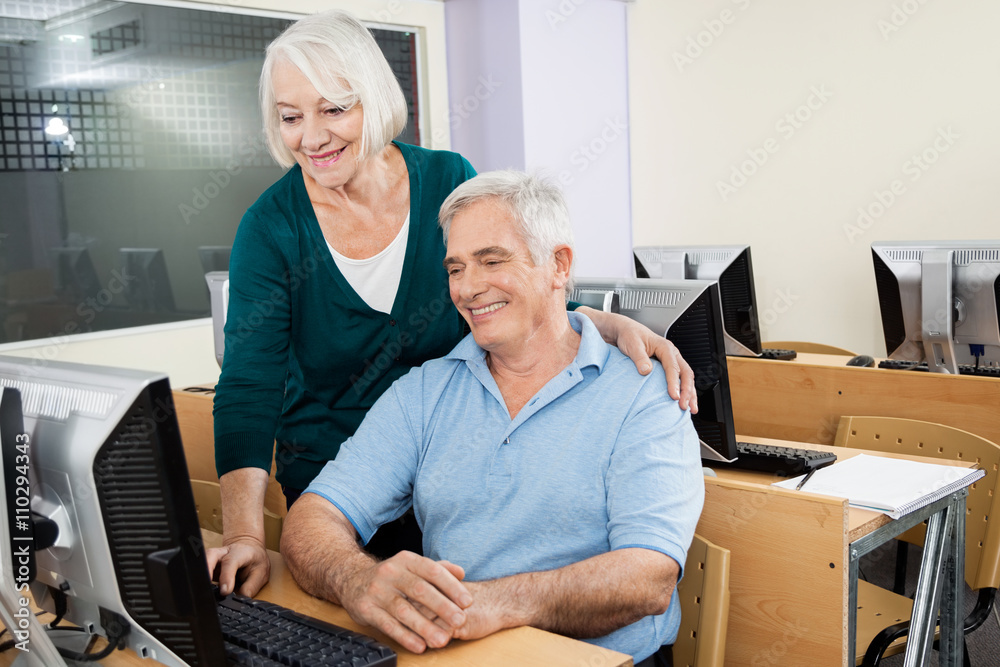 Senior Man And Woman Using Computer In Class Senior Man And Woman Using Computer In Class