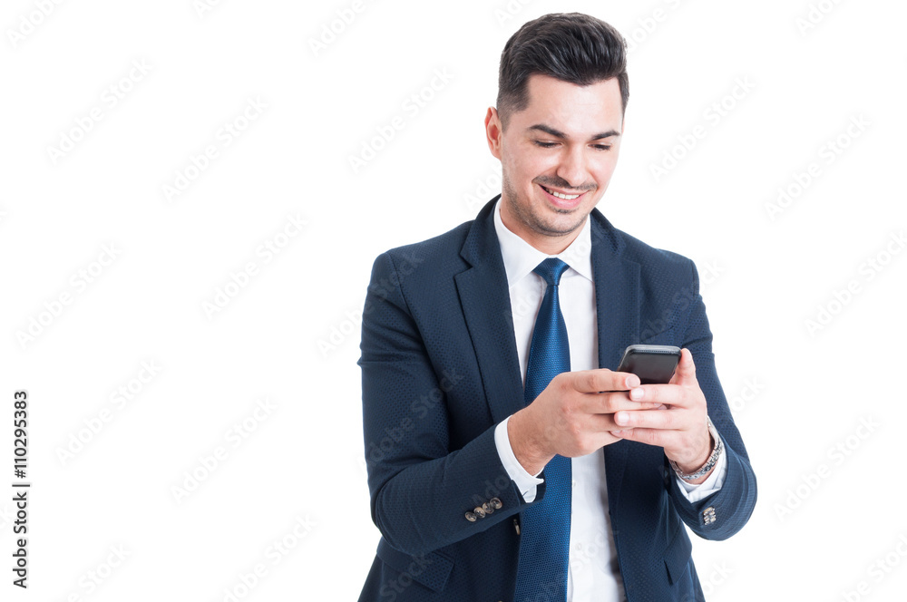 Cheerful business man using cellphone for sending a message Cheerful business man using cellphone for sending a message