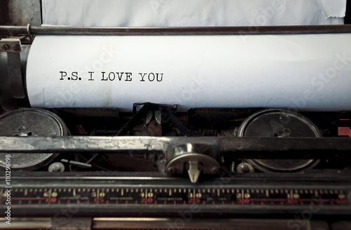 close up image of typewriter with paper sheet and the phrase: p.s. i love you. copy space for your text. retro filtered  photo