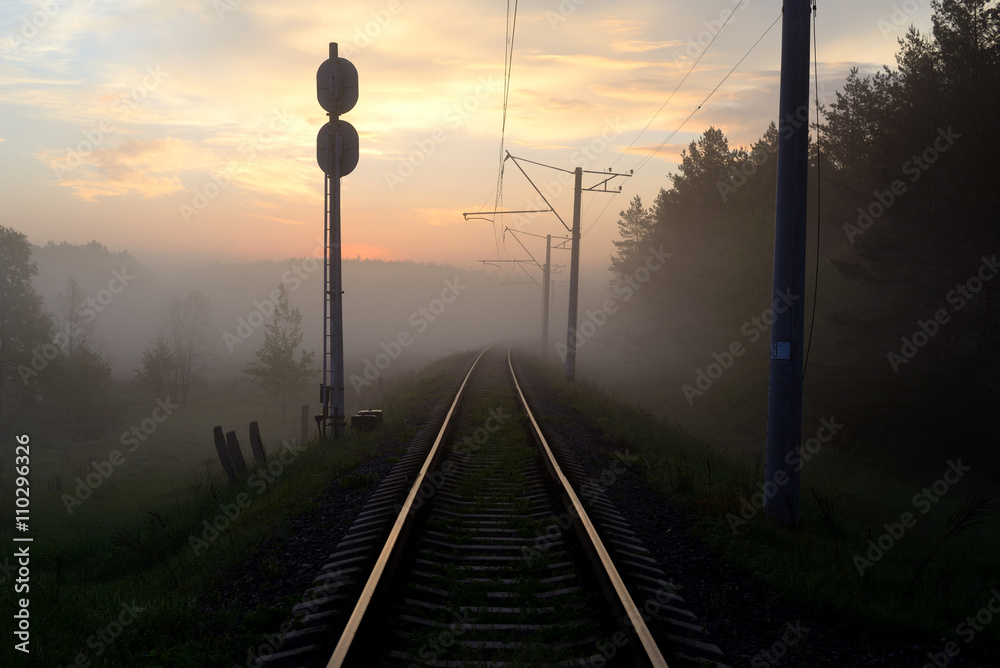 Sunrise and morning mist over the railway