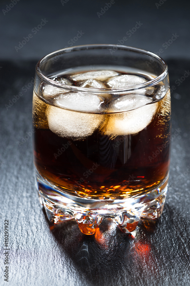 cola with ice in a glass, vertical cola with ice in a glass, vertical