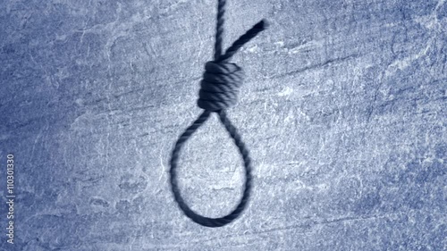 Noose hanging in front of stone wall film clip. Symbol of death, capital punishment and execution.