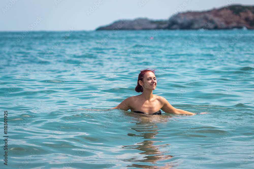 Sexy Young Woman in Bikini Enjoying Summer Sun during holidays in the Sea, Crete