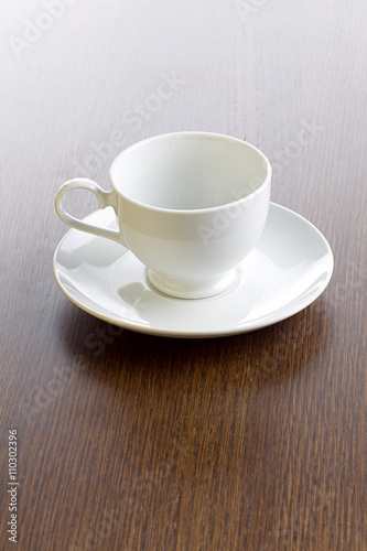 cup and saucer on wooden surface