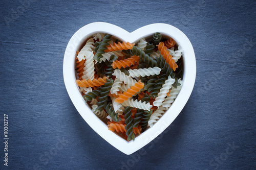 Heart shaped bowl filled with Tri Color Fusilli photo