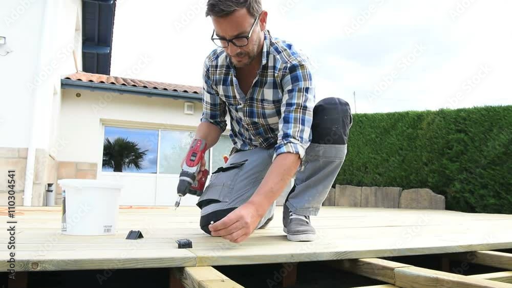 Carpenter building wooden deck Carpenter building wooden deck