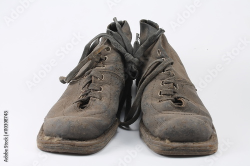 Old dusty shoes on a white background