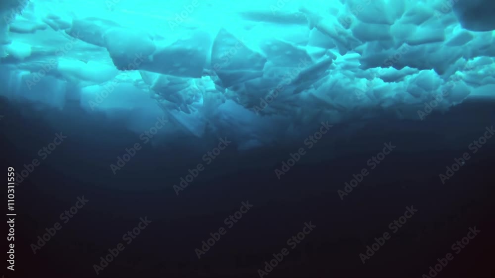 Unique extreme underwater shooting scuba dive beneath ice at geographic North Pole in cold waters. Fantastic views of the lump of ice in water. ICE CAMP BARNEO, NORTH POLE, ARCTIC - APRIL 2015 Unique extreme underwater shooting scuba dive beneath ice at geographic North Pole in cold waters. Fantastic views of the lump of ice in water. ICE CAMP BARNEO, NORTH POLE, ARCTIC - APRIL 2015
