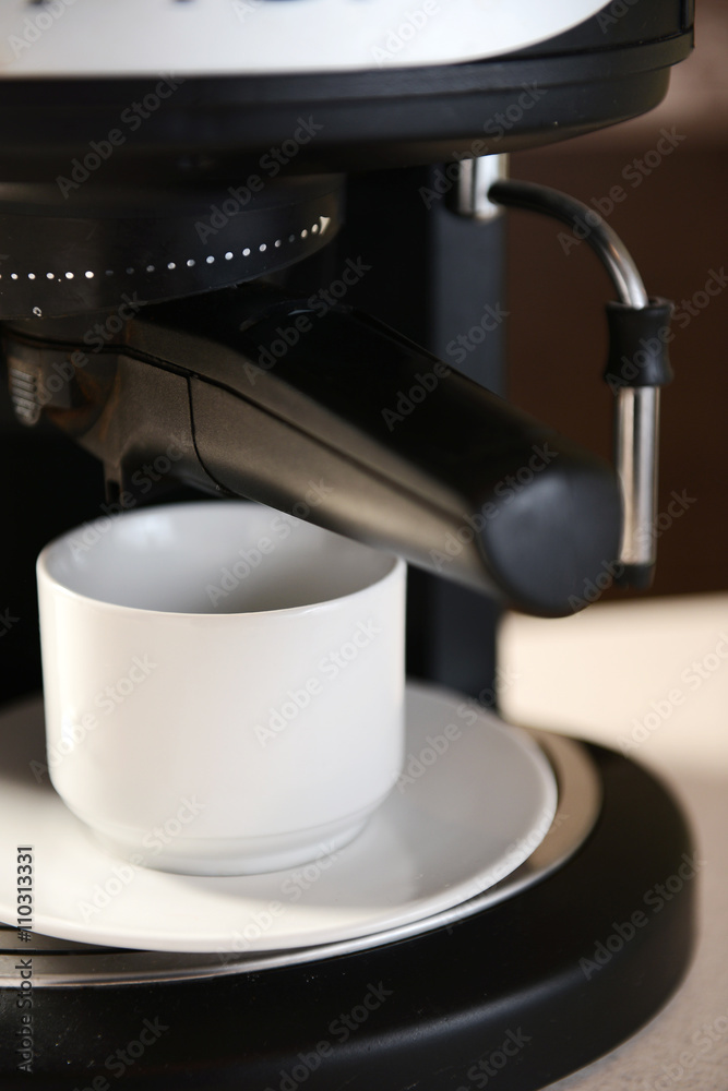 White cup  in the coffee machine