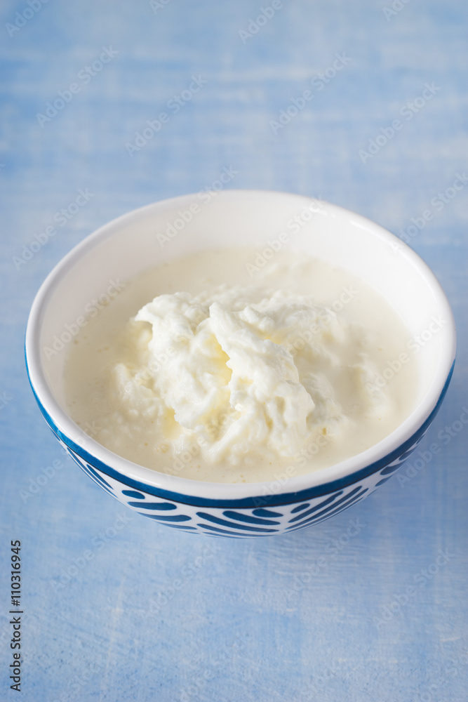 Delicious creamy filling of Apulian burrata cheese, called stracciatella. Selective focus.