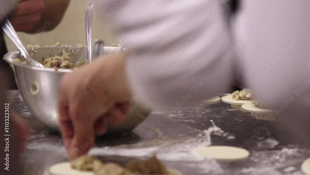 Womens cooking dumplings with meat. Womens cooking dumplings with meat.