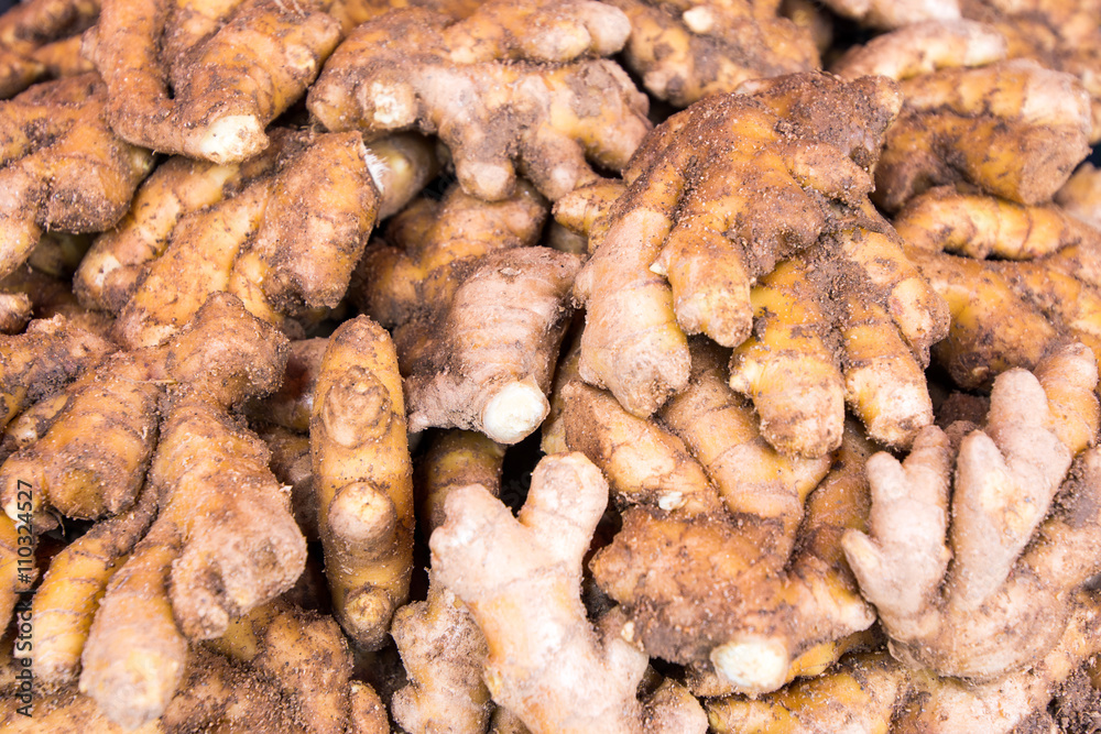 Large pile of fresh root ginger for sale at market
