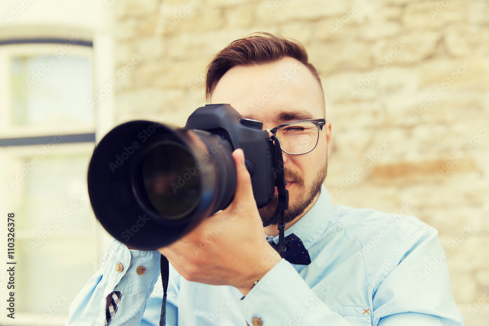 young hipster man with digital camera in city young hipster man with digital camera in city