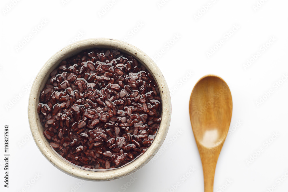 gruel (dark violet rice) in ceramic bow and wooden spoon isolated on white background (top view) gruel (dark violet rice) in ceramic bow and wooden spoon isolated on white background (top view)