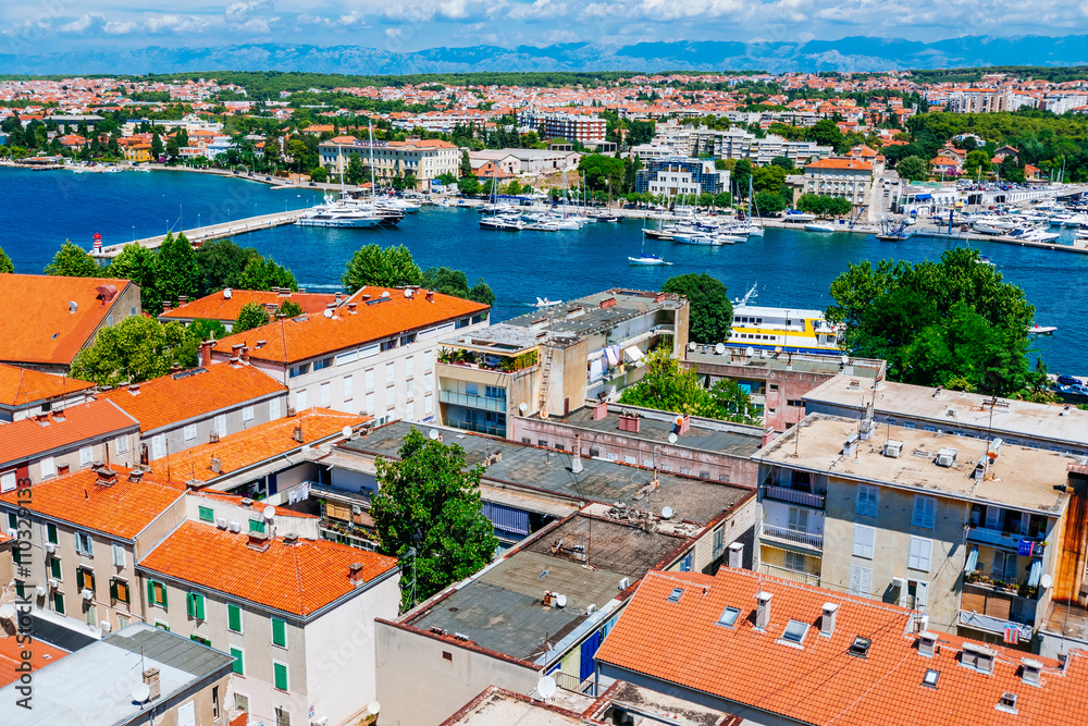 Sunny summer day above old town of Zadar. Panoramic view from the height at center of Zadar and red rooftops.