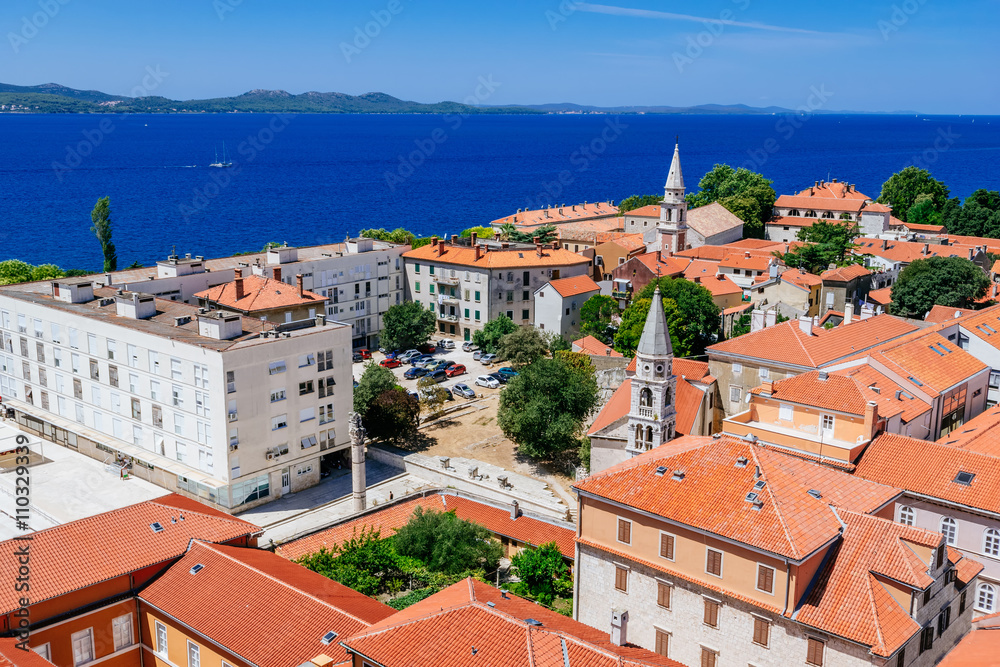 Sunny summer day above old town of Zadar. Panoramic view from the height at center of Zadar and red rooftops.