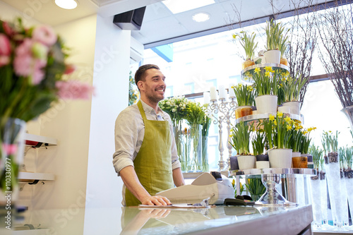 florist man or seller at flower shop counter