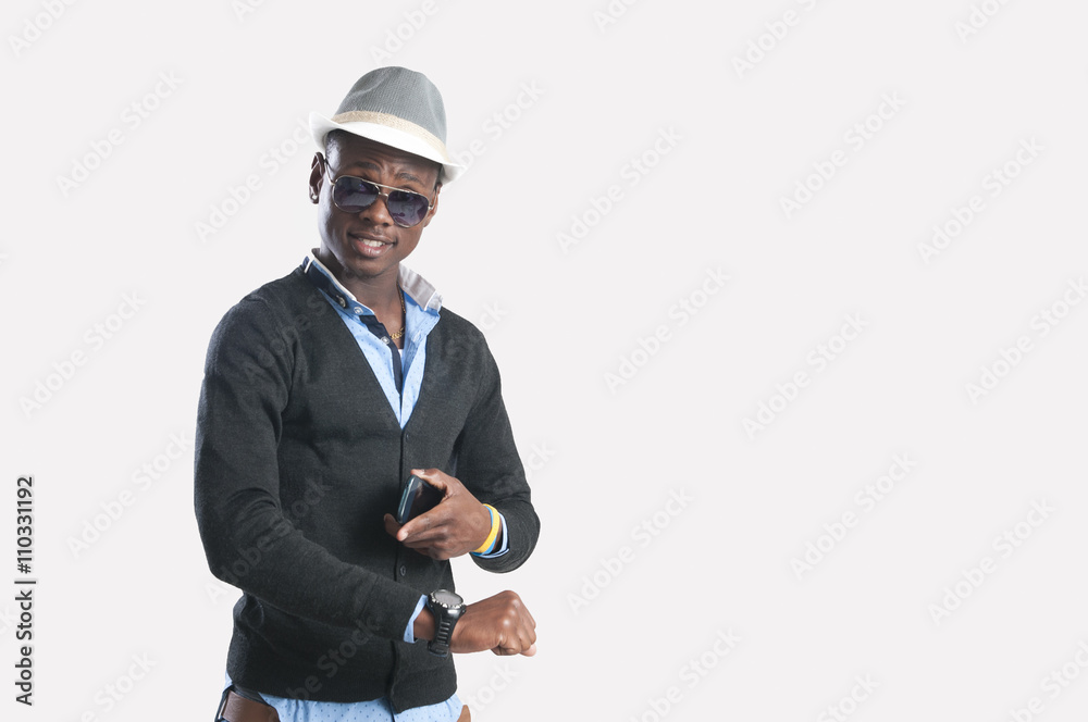 Young african American man using a mobile phone and looking the time Young african American man using a mobile phone and looking the time