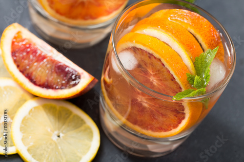 Fototapeta Naklejka Na Ścianę i Meble -  fresh homemade lemonade with red oranges, lemon and mint