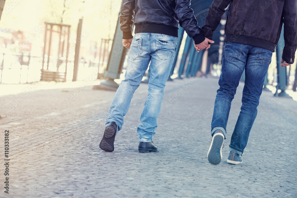 two men holding hands