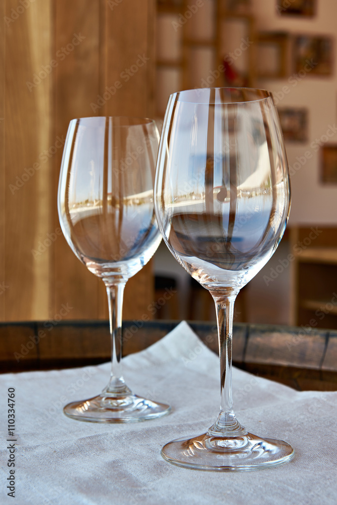 Empty wine glasses on wooden barrel Empty wine glasses on wooden barrel