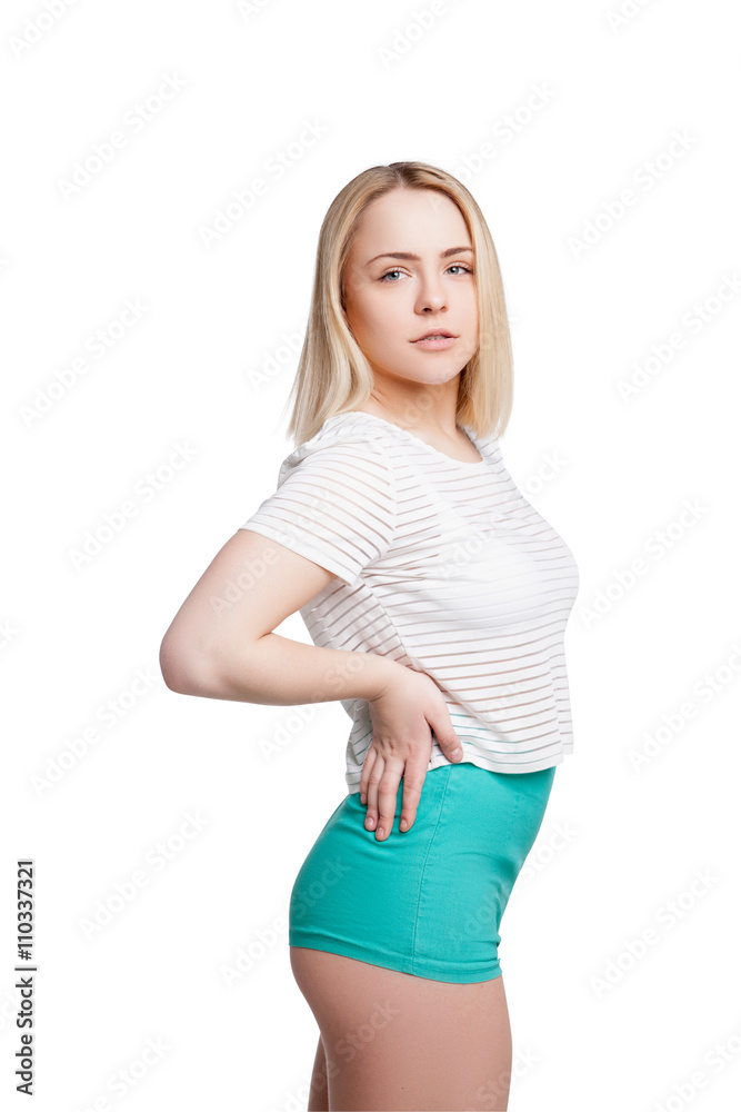 Pretty young woman wearing shorts and tshirt posing isolated Pretty young woman wearing shorts and tshirt posing isolated